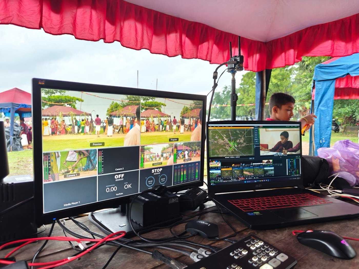Live multiview and drone feed on the control desk under a festival tent