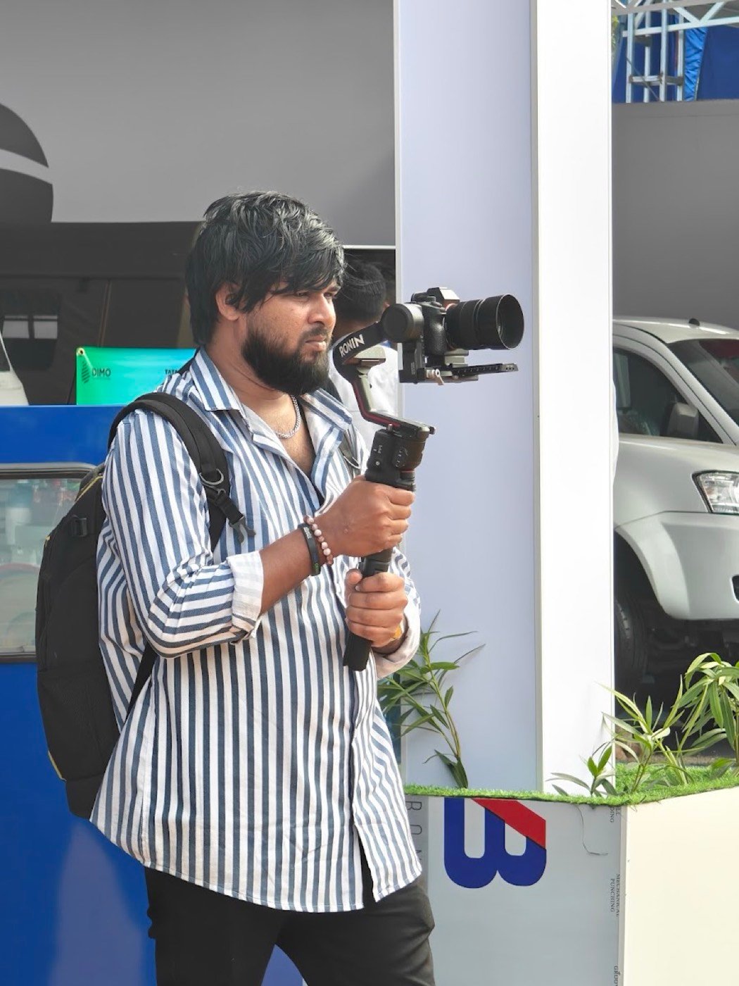 A WhiteFox camera operator filming with a gimbal at an expo