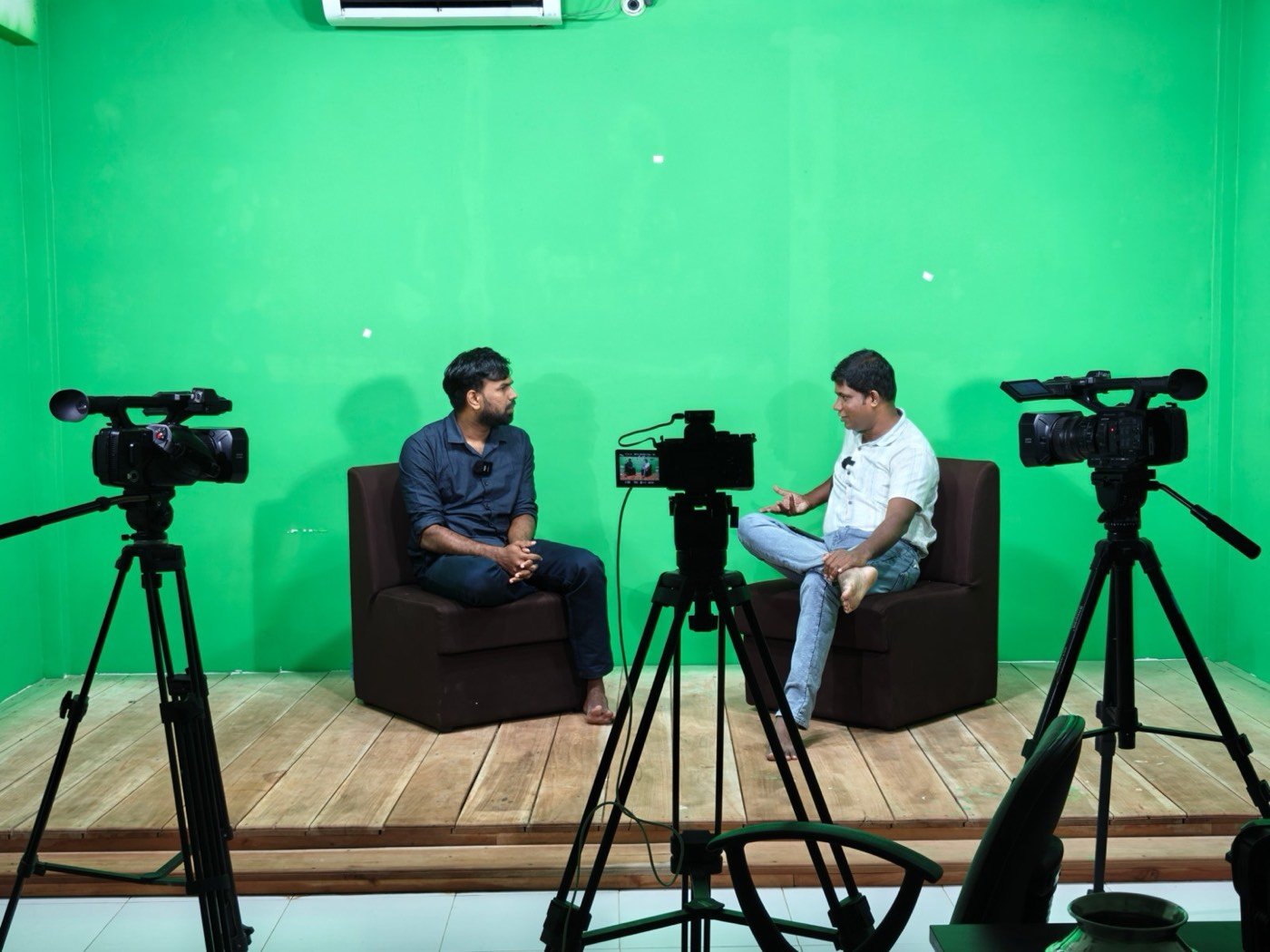 An interview being recorded with three cameras in the WhiteFox green-screen studio